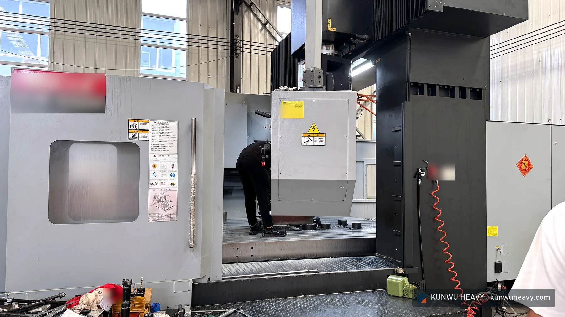 Operator aligning a workpiece on the gantry machining centre table